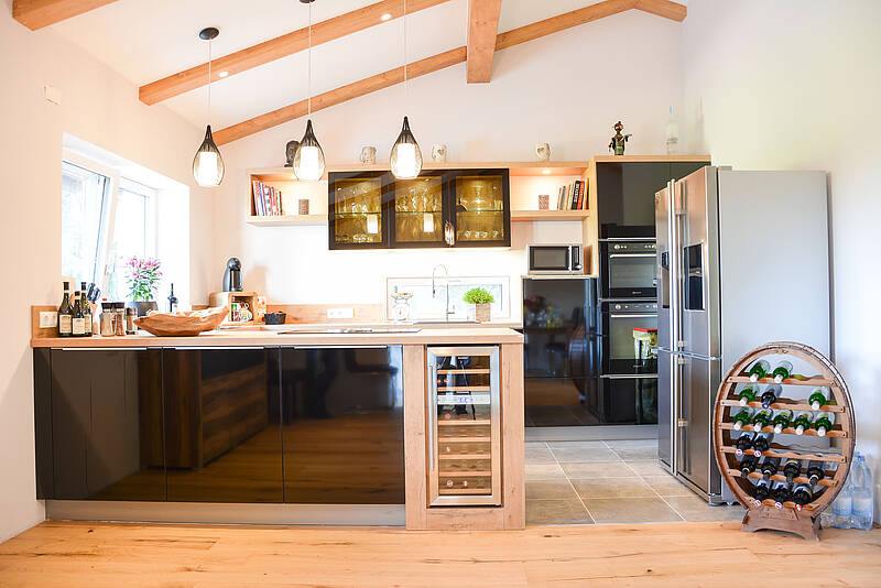 Küche in U-Form mit integrierter Kochinsel und freistehenden Kühlschrank.