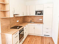 L-Küche mit Holz-Optik passend zum Fußboden.